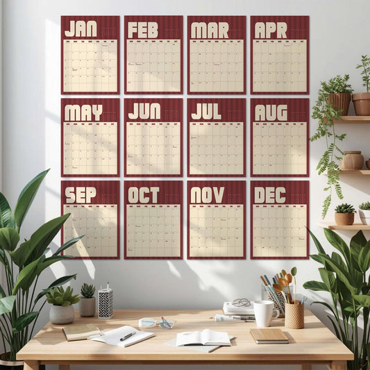 May include: A wall calendar set featuring twelve individual monthly sheets arranged in a grid. Each sheet displays a month name in large cream-colored letters against a dark red striped background, with a cream-colored grid for dates below.