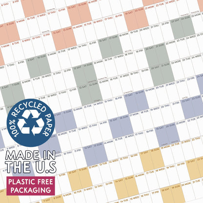 May include: A wall calendar featuring a grid layout with alternating colored blocks in peach, sage green, periwinkle, and yellow. A circular blue badge states 100% RECYCLED PAPER, MADE IN THE U.S, and PLASTIC FREE PACKAGING in white text.