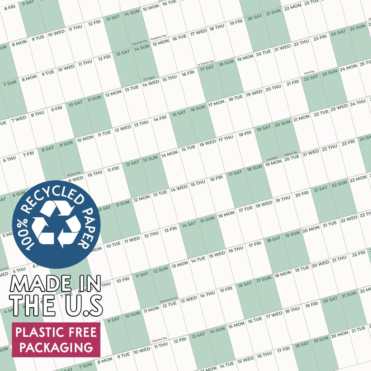 May include: A wall calendar featuring a grid layout with alternating white and light green columns for days of the week. A blue circular badge displays the text 100% RECYCLED PAPER, MADE IN THE U.S, and PLASTIC FREE PACKAGING.