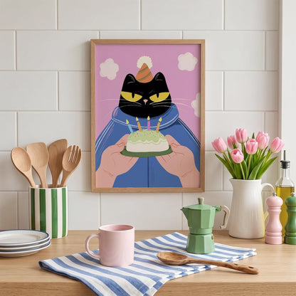 May include: A framed art print featuring a black cat wearing a party hat and holding a birthday cake with lit candles. The cat is set against a pink background with white cloud shapes. The print is in a wooden frame.