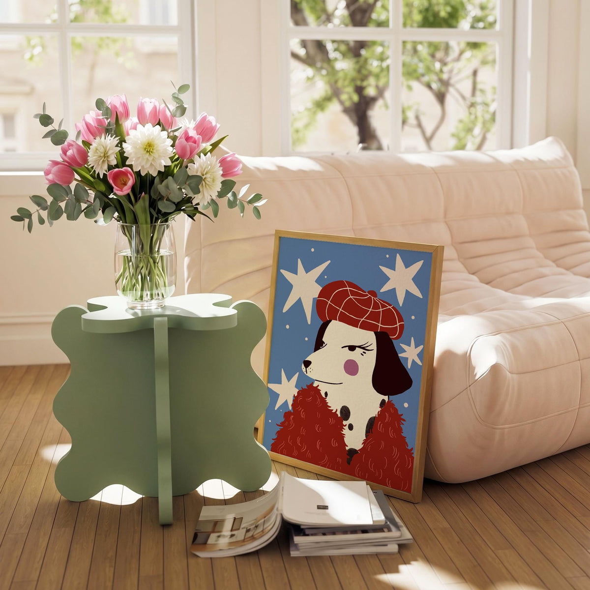 May include: A light green, four-leaf clover shaped side table holds a clear glass vase filled with pink tulips, white dahlias, and eucalyptus. A framed illustration of a Dalmatian in a red beret and coat rests on the floor.