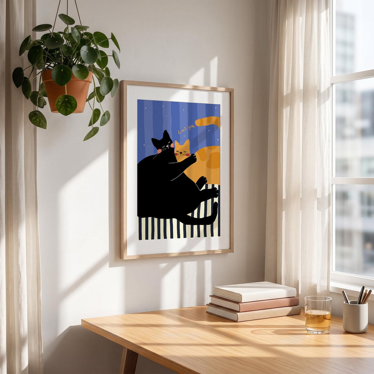 May include: A framed art print featuring two cartoon cats. One black cat is embracing an orange cat. The background has blue vertical stripes and a black and white striped base. The words "Love me" are written above the orange cat.