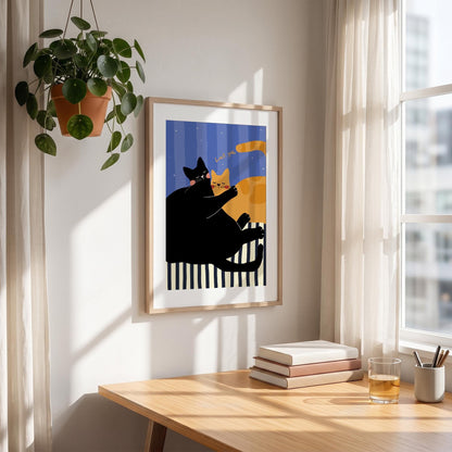 May include: A framed art print featuring two cartoon cats. One black cat is embracing an orange cat. The background has blue vertical stripes and a black and white striped base. The words "Love me" are written above the orange cat.