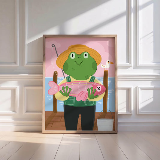May include: A framed illustration of a cartoon frog wearing a straw hat and overalls, holding a pink fish with an X on it. The frog stands on a wooden dock with a fishing rod, a seagull, and a bucket. The background features a pink sky and blue water.