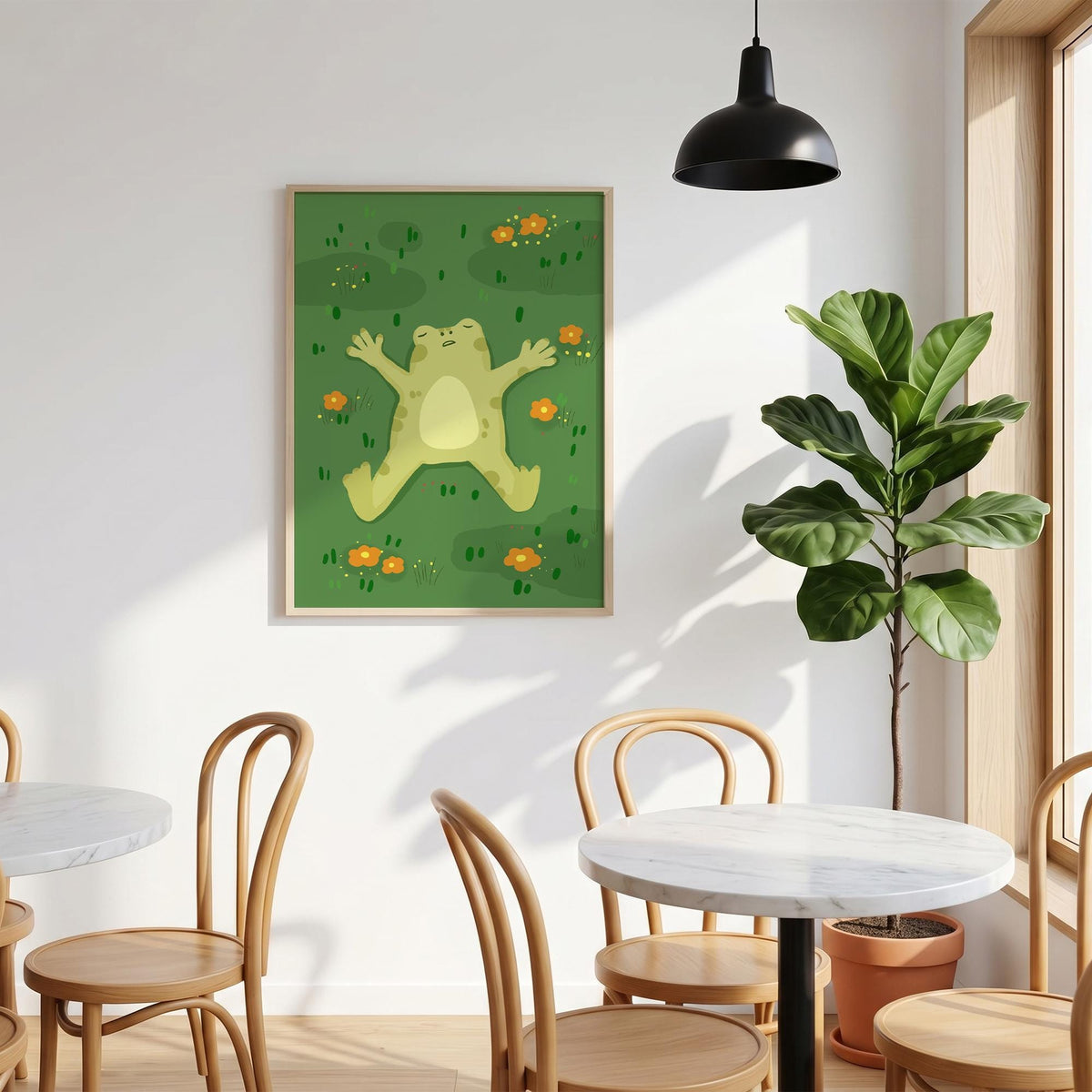 May include: A framed art print featuring a cartoon frog lying on its back in a field of green grass and orange flowers. The frog is light green with a yellow belly. The artwork has a whimsical, playful style.