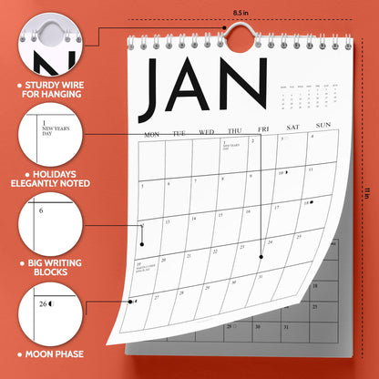 May include: A white wall calendar for January, with a sturdy wire for hanging. The calendar is 8.5 inches wide and 11 inches tall, with holidays elegantly noted and big writing blocks. The moon phase is also indicated.