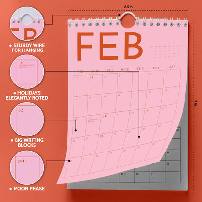 May include: Pink wall calendar with the month of February displayed. The calendar has a sturdy wire for hanging, holidays elegantly noted, and big writing blocks. The calendar is 8.5 inches wide and 11 inches tall.
