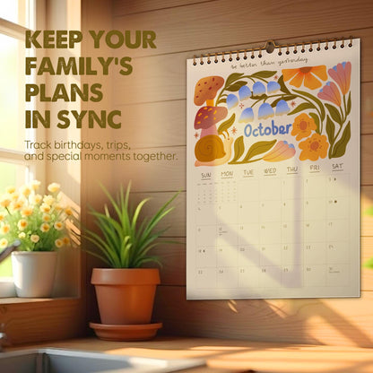 May include: A wall calendar for October with floral illustrations and the text "October." The calendar is hanging on a wooden wall. The text "Keep your family's plans in sync" is also visible.