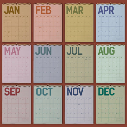 May include: A collection of twelve monthly wall calendars, each with a different color scheme and the month's name at the top. The calendars are arranged in a grid, showcasing the months from January to December. The background is a solid reddish-brown.