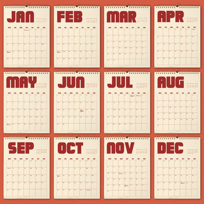 May include: A collection of twelve monthly wall calendars, each displaying a different month from January to December. The calendars have a cream-colored background with red text and a spiral binding at the top. The months are printed in bold, uppercase letters.