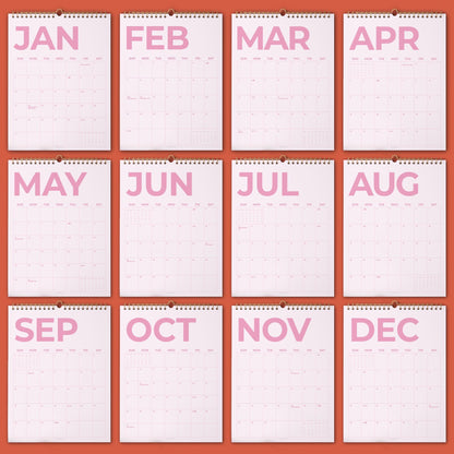 May include: A twelve-month wall calendar set featuring white pages with large, bold, light pink lettering for each month from January to December. Each page includes a grid layout for days of the week and dates, bound with a metal spiral at the top.