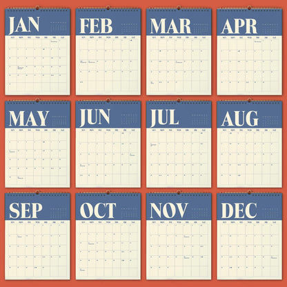 May include: A twelve-month wall calendar featuring a blue header for each month with white serif lettering for the month names. Each page displays a grid for the days of the week, starting with Sunday, against a cream-colored background.