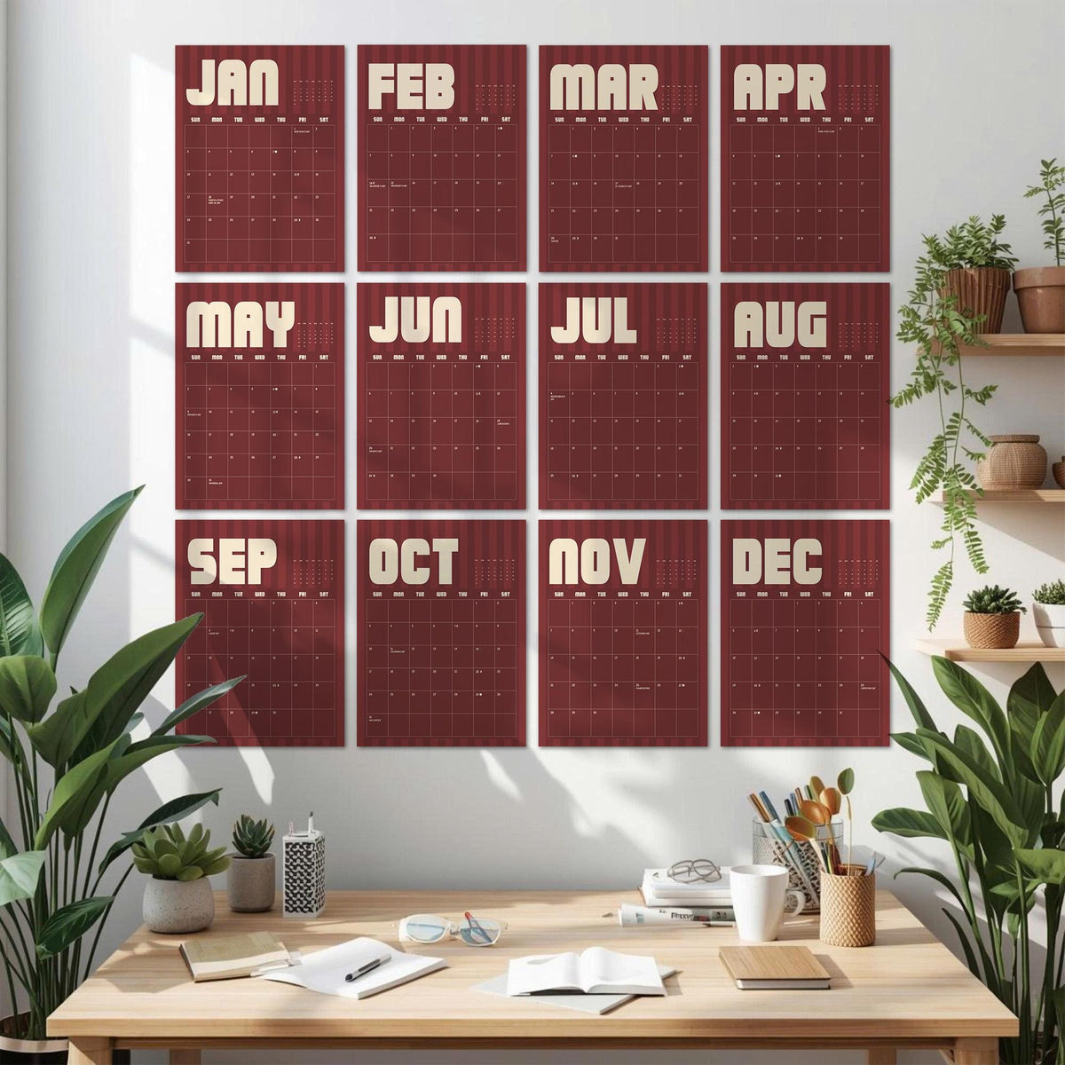 May include: A wall calendar set featuring twelve rectangular sheets, each representing a month from January to December. The sheets are deep red with vertical stripes and display the month name in large cream letters above a grid of dates.
