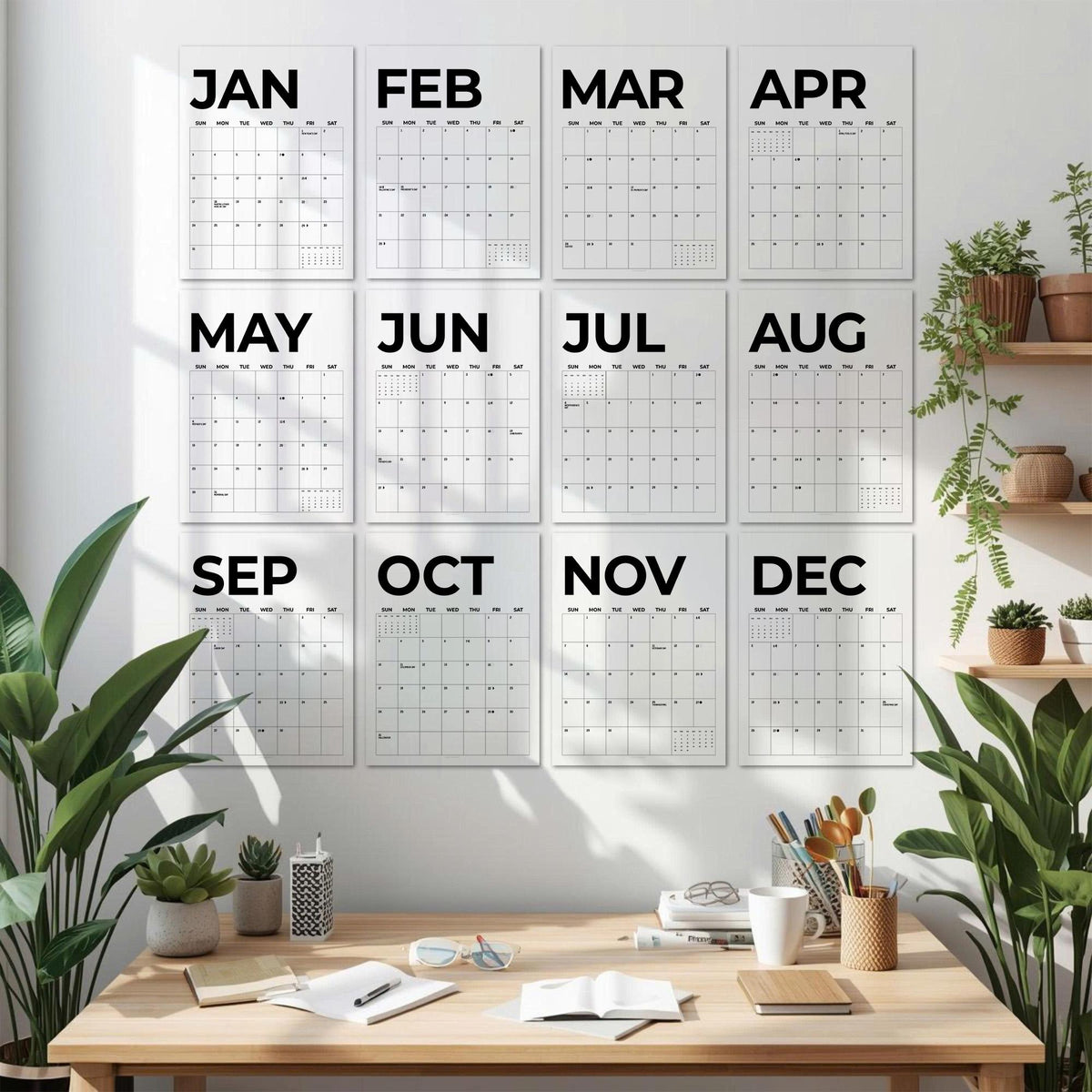 May include: A wall display featuring twelve individual white calendar sheets arranged in a grid, each labeled with a month from January to December in bold black text. The grid includes daily squares and a light gray grid pattern for scheduling.