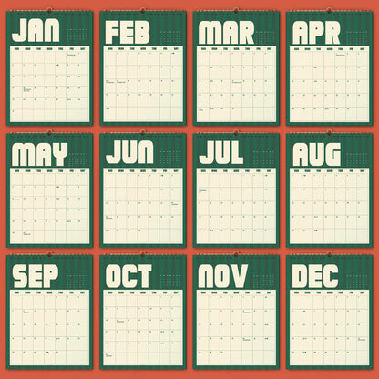 May include: A twelve-month wall calendar featuring a dark green background with vertical stripes and cream-colored grid pages. Each month is labeled with bold, rounded white lettering from JAN to DEC, displaying a standard seven-column grid layout.