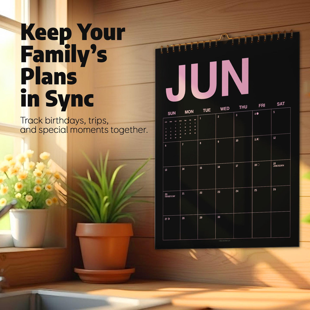 May include: A black wall calendar with the text JUN in large pink letters at the top. The calendar features a grid for the month with white lines and numbers. The text Keep Your Family's Plans in Sync and Track birthdays, trips, and special moments together is printed on the left side.