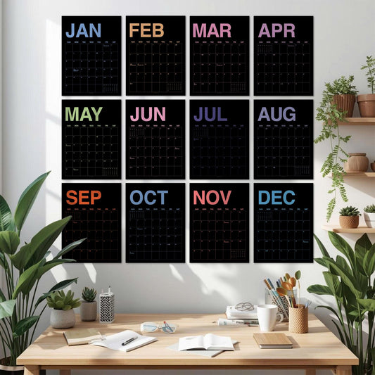 May include: A set of twelve black wall calendars arranged in a grid, each featuring a different month name in a unique pastel color at the top. The calendars display a grid for dates with thin white lines against a black background for each month.