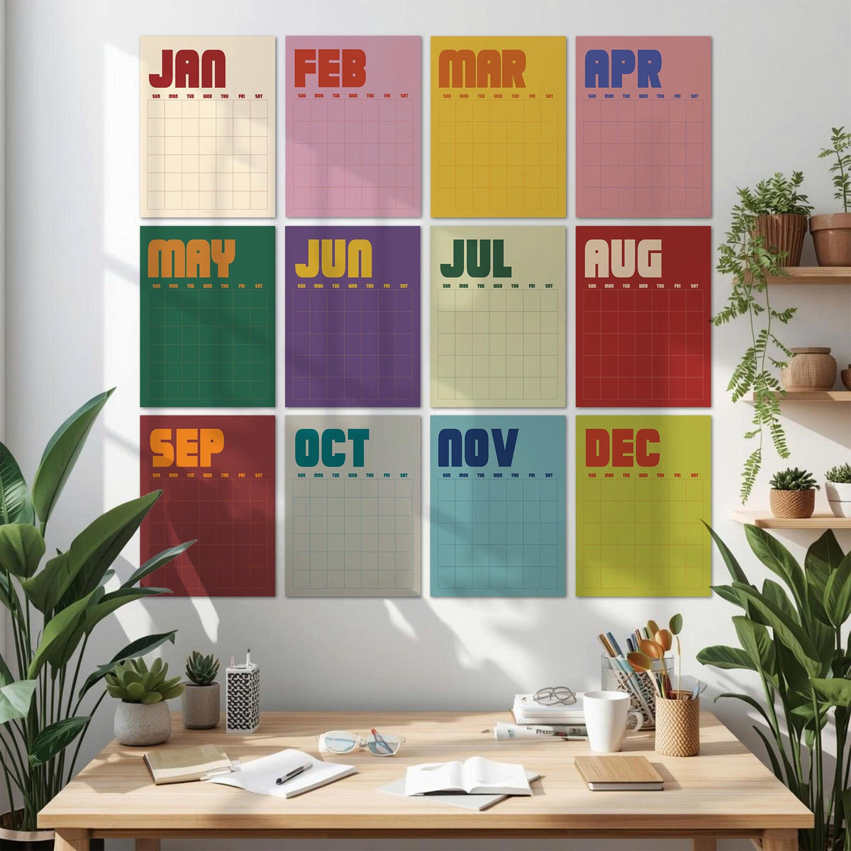 May include: A wall calendar set featuring twelve rectangular sheets, each representing a month from January to December. Each sheet displays the month name in bold, colorful typography above a grid for daily planning, arranged in a three-by-four grid.