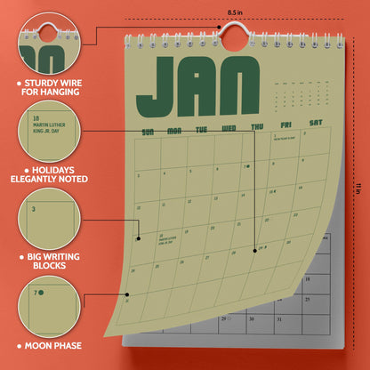 May include: A wall calendar measuring 8.5 inches by 11 inches with a light olive green background and dark green text. It features a white wire binding for hanging, large daily writing blocks, marked holidays like Martin Luther King Jr. Day, and moon phases.