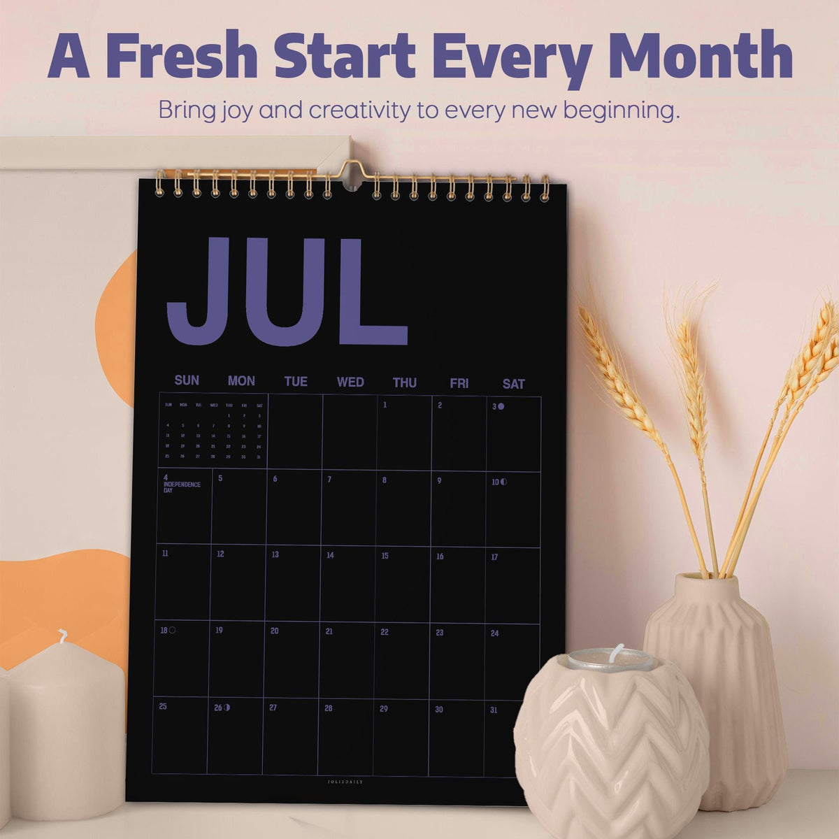 May include: A wall calendar with a black background and purple text displaying the month of July. The calendar features a grid layout with days of the week and dates. The text A Fresh Start Every Month and Bring joy and creativity to every new beginning is printed above the calendar.