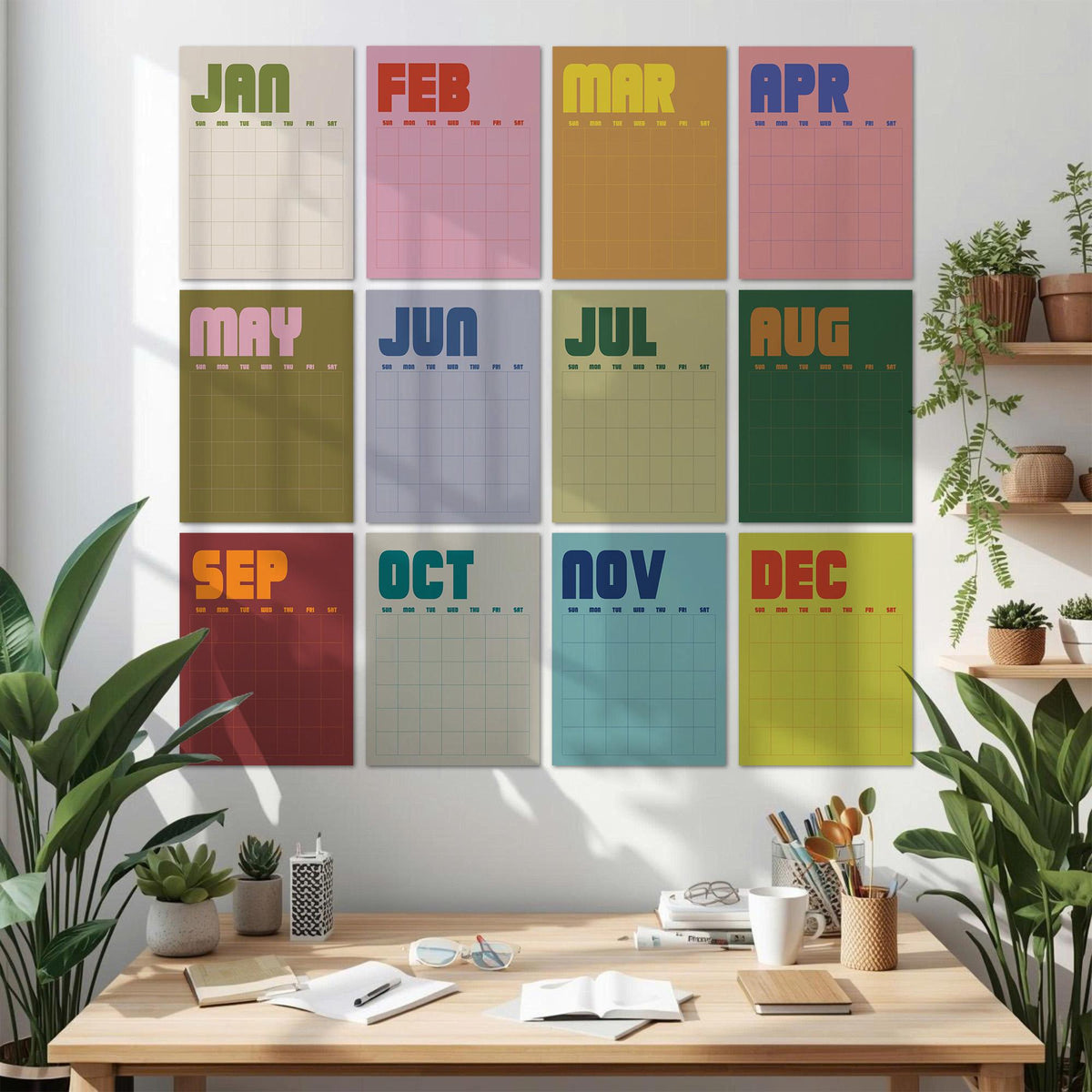 May include: A set of twelve rectangular wall calendar sheets, each featuring a different month from January to December. Each sheet displays a bold, colorful header with the month name and a grid for daily planning, arranged in a four-by-three grid.