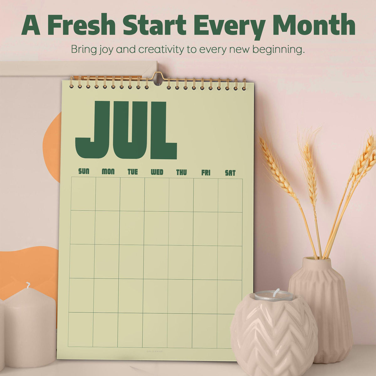 May include: A wall calendar with a light green background and dark green text reading JUL, featuring a grid for days of the week. The top text reads A Fresh Start Every Month and Bring joy and creativity to every new beginning.
