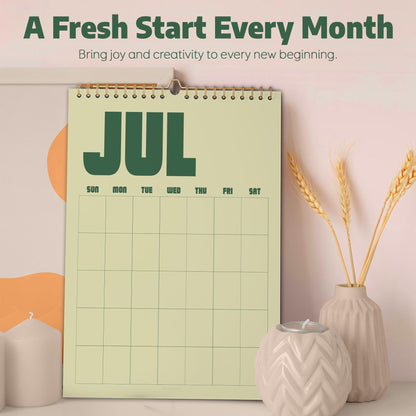 May include: A wall calendar with a light green background and dark green text reading JUL, featuring a grid for days of the week. The top text reads A Fresh Start Every Month and Bring joy and creativity to every new beginning.