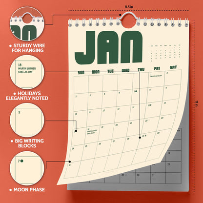 May include: A wall calendar measuring 8.5 inches by 11 inches with a cream background and dark green text. It features a sturdy wire for hanging, large writing blocks for dates, noted holidays like Martin Luther King Jr. Day, and moon phases.