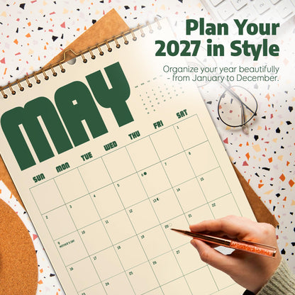 May include: A wall calendar for May 2027 with a cream-colored page, dark green bold lettering, and a grid layout. The text reads Plan Your 2027 in Style, Organize your year beautifully - from January to December, and Mother's Day on the ninth.