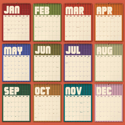 May include: A twelve-month wall calendar featuring a grid layout for each month from January to December. Each month is displayed on a separate page with a distinct color background, bold white lettering for the month name, and a cream-colored grid.