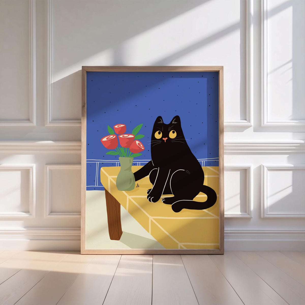 May include: A framed art print featuring a black cat with yellow eyes sitting on a yellow table. A green vase with red roses sits on the table. The background is blue with white lines, and the frame is light brown.
