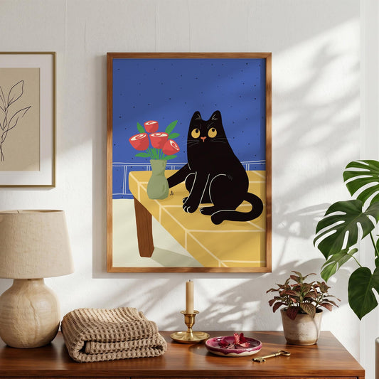 May include: A framed art print featuring a black cat with yellow eyes sitting on a yellow table. A vase of red roses sits next to the cat. The background is blue, and the frame is brown.