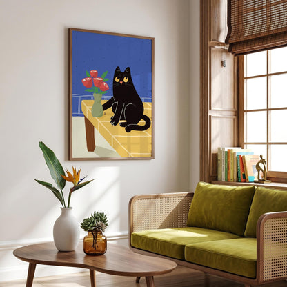 May include: A framed art print featuring a black cat with yellow eyes, sitting on a yellow table with a vase of red roses. The background is blue, and the artwork is in a room with a green sofa and wooden furniture.